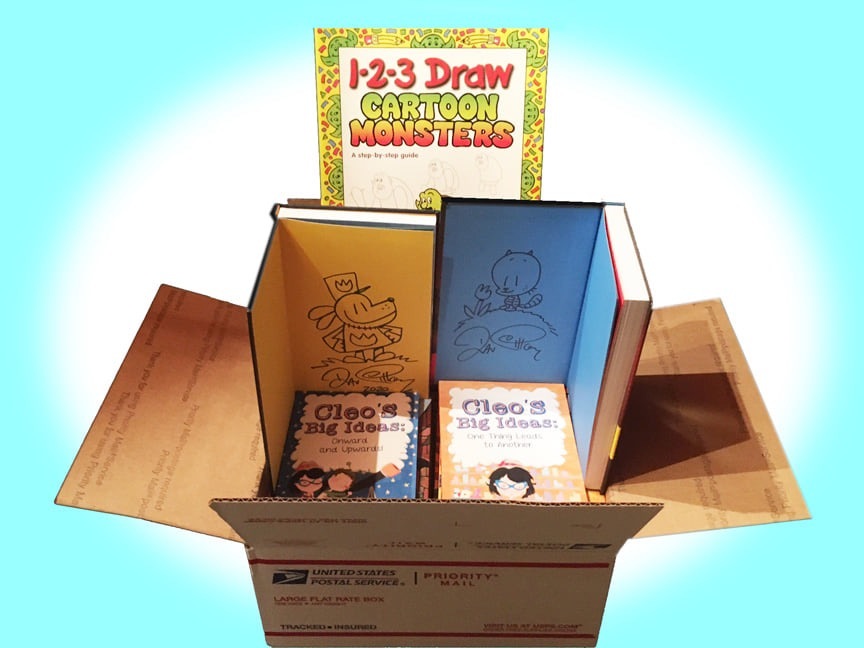 image of a an open box of books highlighted with drawings from Dogman and the covers of Cleo's Big Ideas books 1 and 2. In the background is a sign, 1-2-3 Draw Cartoon Monsters